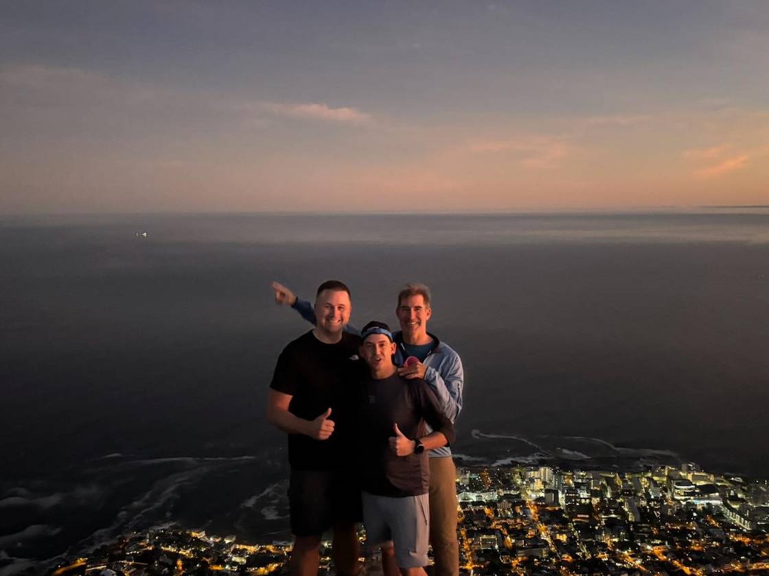 Three people at the top of Lion’s Head above Cape Town at first light